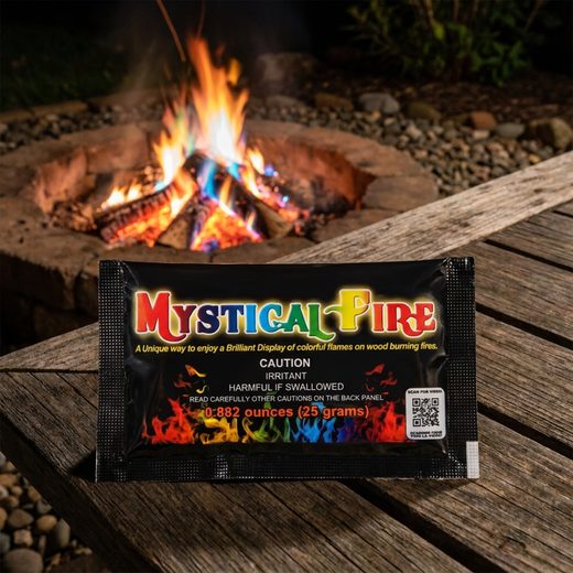 Color changing fire packets tossed into a campfire creating vibrant blue and green flames