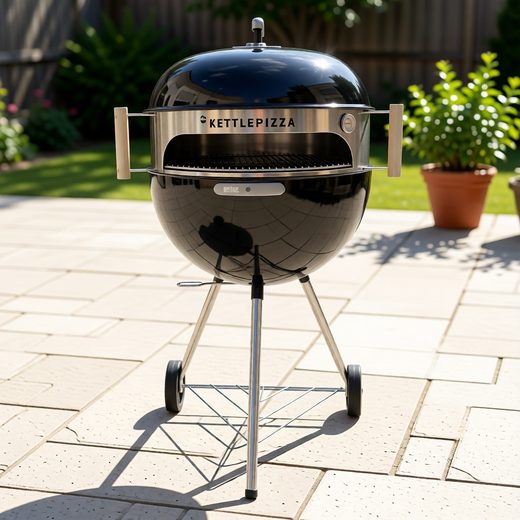 Glossy black kettle pizza oven with a domed lid resting on a metal stand.