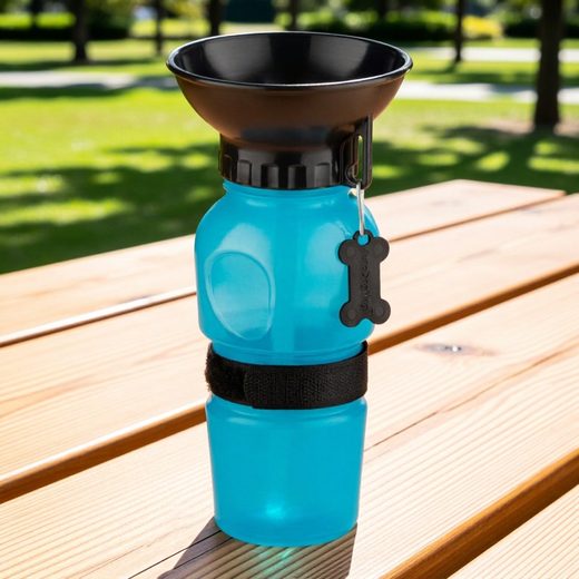 Bright blue dog water bottle with a black feeding bowl and adjustable strap for hiking.
