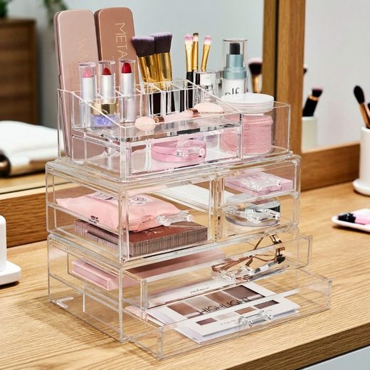 Stackable clear acrylic organizer holding various makeup brushes, palettes, and cosmetics.