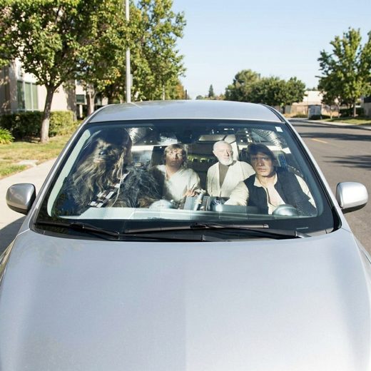 Star Wars Millennium Falcon sunshade covering the windshield of a parked car.